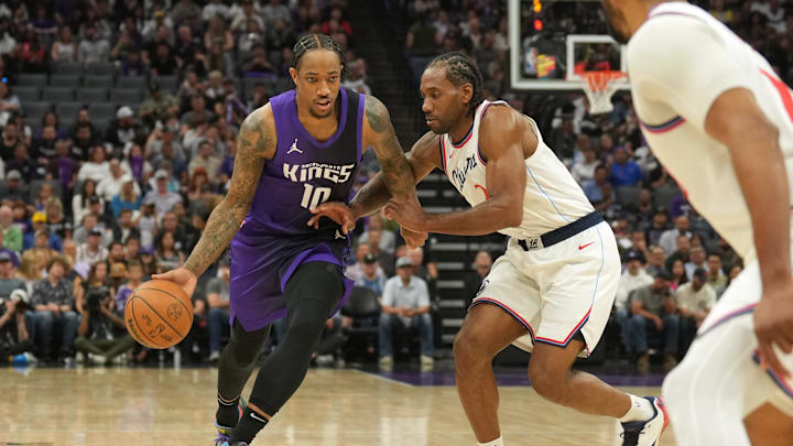 Apr 11, 2025; Sacramento, California, USA; Sacramento Kings forward DeMar DeRozan (10) dribbles against Los Angeles Clippers forward Kawhi Leonard (center right) during the second quarter at Golden 1 Center. Mandatory Credit: Darren Yamashita-Imagn Images
