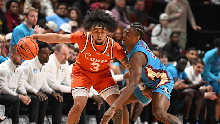 Feb 24, 2026; Tallahassee, Florida, USA; Miami Hurricanes guard Tre Donaldson (3) dribbles the ball as Florida State Seminoles forward Thomas Bassong (3) defends during the first half at Donald L. Tucker Center. Mandatory Credit: Melina Myers-Imagn Images