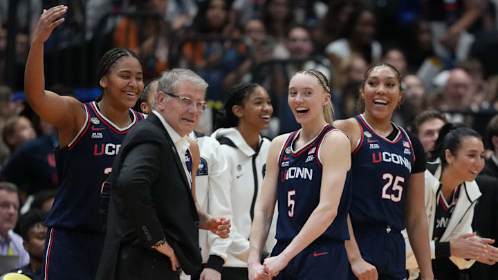 Apr 4, 2025; Tampa, FL, USA;  Connecticut Huskies guard Paige Bueckers (5) reacts with head coach Geno Auriemma on the bench during the fourth quarter in a semifinal of the women's 2025 NCAA tournament against the UCLA Bruins at Amalie Arena. Mandatory Credit: Kirby Lee-Imagn Images