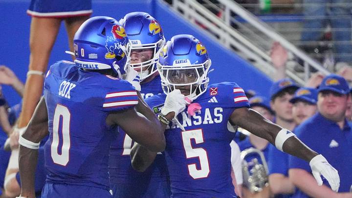 Kansas Jayhawks wide receiver Nik McMillan (5) celebrates with wide receiver Nahzae Cox (0) Kansas Jayhawks wide receiver Nik McMillan (5) celebrates with wide receiver Nahzae Cox (0)