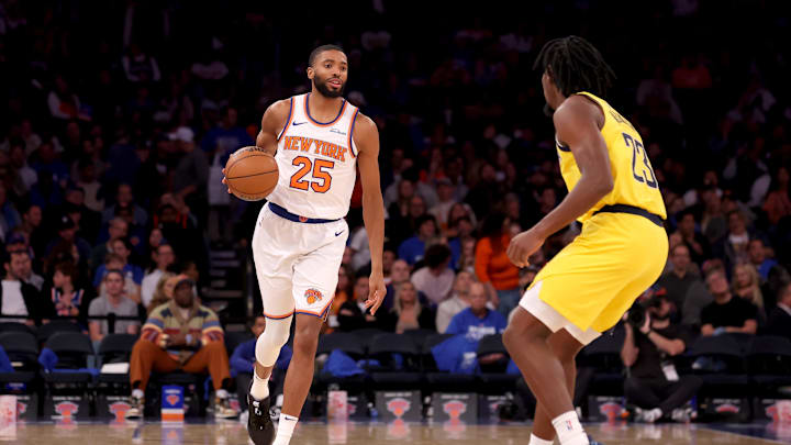 Oct 25, 2024; New York, New York, USA; New York Knicks forward Mikal Bridges (25) brings the ball up court against Indiana Pacers forward Aaron Nesmith (23) during the third quarter at Madison Square Garden. Mandatory Credit: Brad Penner-Imagn Images