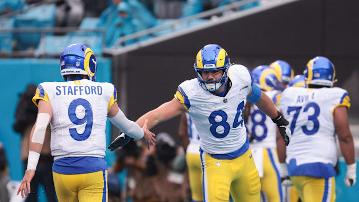 Nov 30, 2025; Charlotte, North Carolina, USA; Los Angeles Rams tight end Colby Parkinson (84) celebrates with Los Angeles Rams quarterback Matthew Stafford (9) during the fourth quarter against the Carolina Panthers at Bank of America Stadium. Mandatory Credit: Scott Kinser-Imagn Images