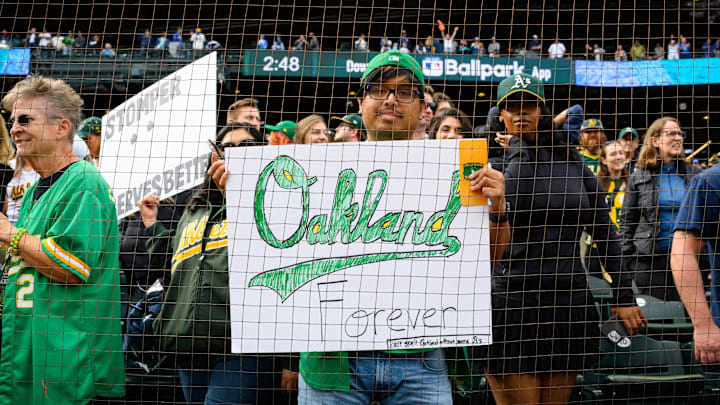 Sep 29, 2024; Seattle, Washington, USA; An Oakland Athletics fan holds a sign after the game between the Seattle Mariners and the Oakland Athletics at T-Mobile Park.