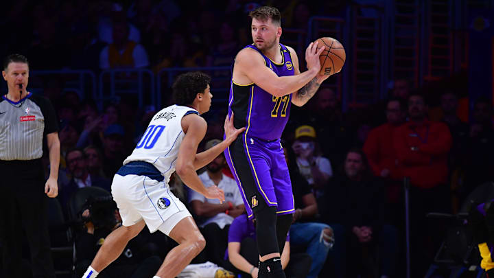 Feb 25, 2025; Los Angeles, California, USA; Los Angeles Lakers guard Luka Doncic (77) looks to move the ball on Dallas Mavericks guard Max Christie (00) during the first quarter at Crypto.com Arena. Mandatory Credit: Gary A. Vasquez-Imagn Images Feb 25, 2025; Los Angeles, California, USA; Los Angeles Lakers guard Luka Doncic (77) looks to move the ball on Dallas Mavericks guard Max Christie (00) during the first quarter at Crypto.com Arena. Mandatory Credit: Gary A. Vasquez-Imagn Images