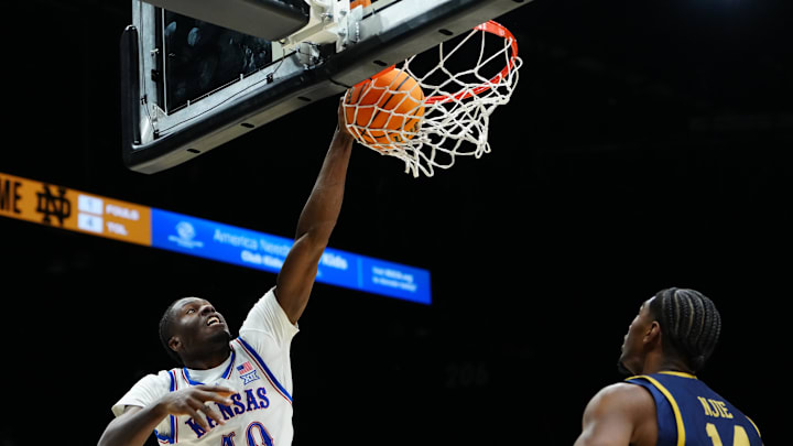 Nov 24, 2025; Las Vegas, Nevada, USA; Kansas Jayhawks forward Flory Bidunga (40) dunks the ball against the Notre Dame Fighting Irish during the first half in a 2025 Players Era Festival group play game at MGM Grand Garden Arena. Mandatory Credit: Stephen R. Sylvanie-Imagn Images