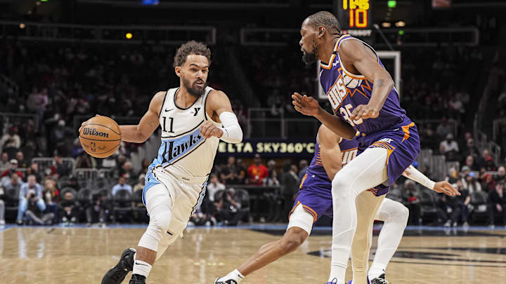 Jan 14, 2025; Atlanta, Georgia, USA; Atlanta Hawks guard Trae Young (11) dribbles against Phoenix Suns forward Kevin Durant (35) during the first half at State Farm Arena. Mandatory Credit: Dale Zanine-Imagn Images