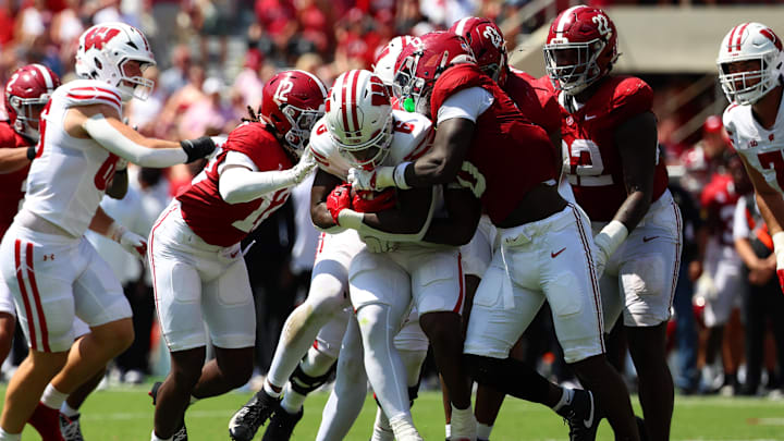 Wisconsin Badgers running back Darrion Dupree (6) is tackled by a host of Alabama Crimson Tide defenders