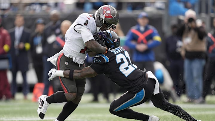 Tampa Bay Buccaneers running back Bucky Irving (7) runs against Carolina Panthers safety Nick Scott