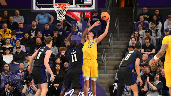 Jan 14, 2026; Seattle, Washington, USA; Michigan Wolverines center Aday Mara (15) shoots the ball over Washington Huskies center Franck Kepnang (11) during the first half at Alaska Airlines Arena at Hec Edmundson Pavilion. Mandatory Credit: Steven Bisig-Imagn Images