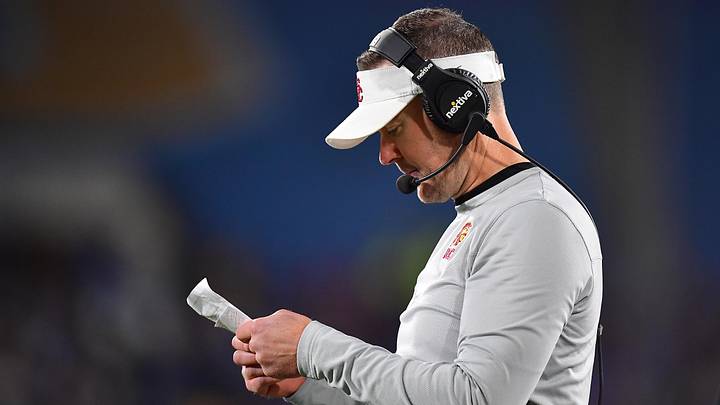 Nov 19, 2022; Pasadena, California, USA; Southern California Trojans head coach Lincoln Riley reviews game notes during the first half at the Rose Bowl. Mandatory Credit: Gary A. Vasquez-Imagn Images