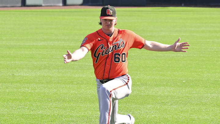 Feb 10, 2026; Scottsdale, AZ, USA;  San Francisco Giants pitcher Hayden Birdsong (60) stretches during a Spring Training workout at Scottsdale Stadium Mandatory Credit: Matt Kartozian-Imagn Images