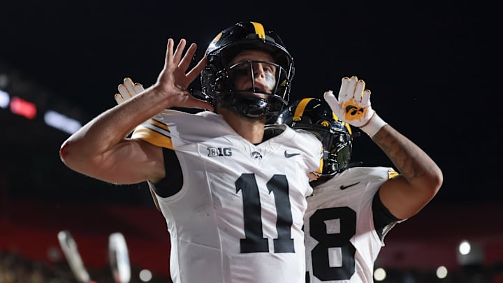 Sep 19, 2025; Piscataway, New Jersey, USA; Iowa Hawkeyes quarterback Mark Gronowski (11) reacts after scoring a rushing touchdown during the fourth quarter against the Rutgers Scarlet Knights at SHI Stadium. Mandatory Credit: Vincent Carchietta-Imagn Images Sep 19, 2025; Piscataway, New Jersey, USA; Iowa Hawkeyes quarterback Mark Gronowski (11) reacts after scoring a rushing touchdown during the fourth quarter against the Rutgers Scarlet Knights at SHI Stadium. Mandatory Credit: Vincent Carchietta-Imagn Images
