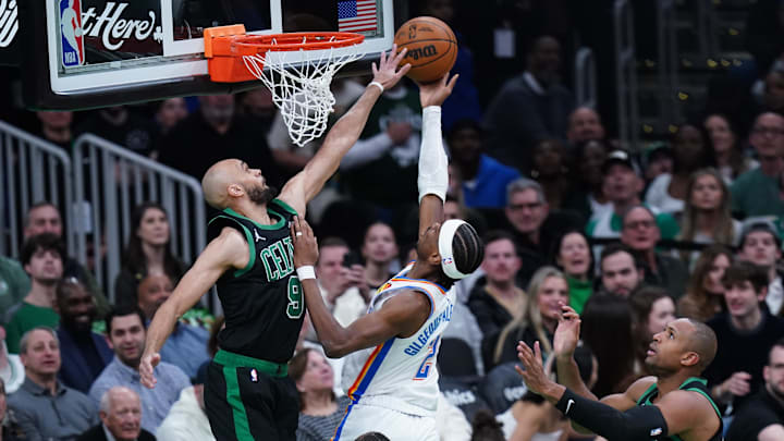 Mar 12, 2025; Boston, Massachusetts, USA; Oklahoma City Thunder guard Shai Gilgeous-Alexander (2) scores against Boston Celtics guard Derrick White (9) in the first quarter at TD Garden. Mandatory Credit: David Butler II-Imagn Images