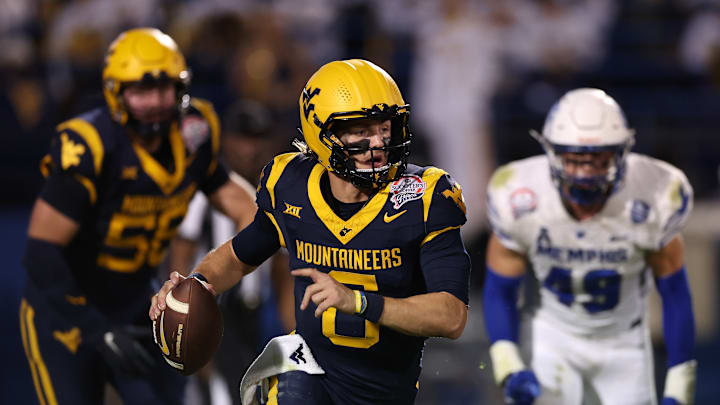 WVU quarterback Garrett Greene runs with the ball during the 2024 Scooter's Coffee Frisco Bowl.