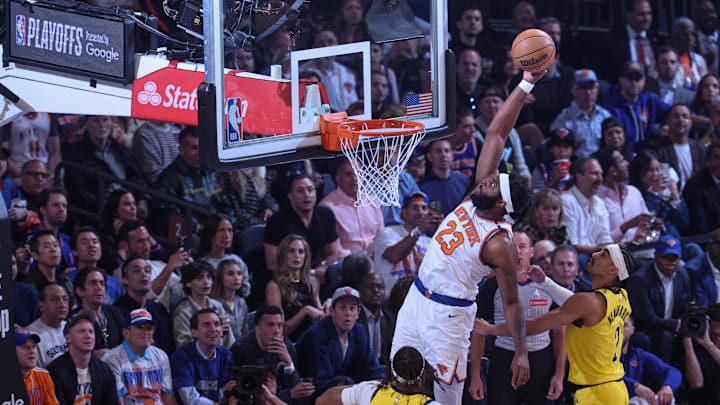 May 29, 2025; New York, New York, USA; New York Knicks center Mitchell Robinson (23) goes up for a dunk in game five of the eastern conference finals of the 2025 NBA Playoffs against Indiana Pacers center Myles Turner (33) at Madison Square Garden. Mandatory Credit: Vincent Carchietta-Imagn Images