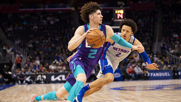 Feb 11, 2022; Detroit, Michigan, USA; Charlotte Hornets guard LaMelo Ball (2) gets defended by Detroit Pistons guard Cade Cunningham (2) during the first quarter at Little Caesars Arena. Mandatory Credit: Raj Mehta-Imagn Images