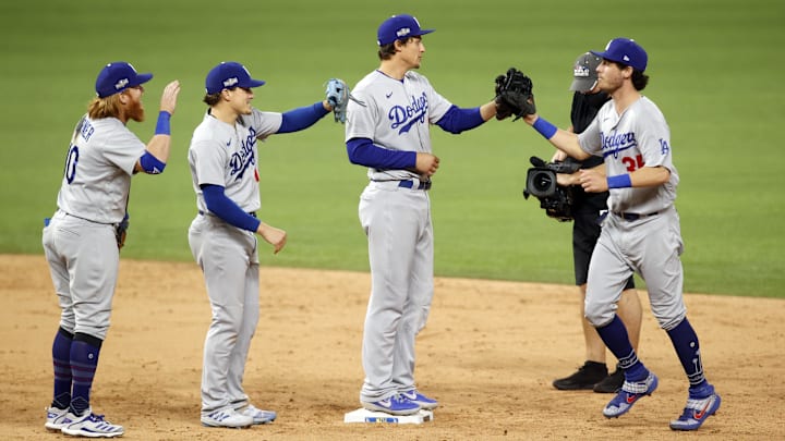 Oct 16, 2020; Arlington, Texas, USA; Los Angeles Dodgers third baseman Justin Turner (10) second baseman Enrique Hernandez (14) shortstop Corey Seager (5) and center fielder Cody Bellinger (35) celebrate their 7-3 win over the Atlanta Braves in game five of the 2020 NLCS at Globe Life Field. Mandatory Credit: Tim Heitman-Imagn Images