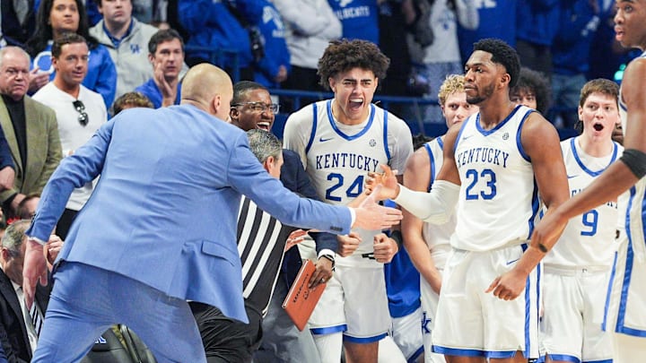 Kentucky Wildcats head coach Mark Pope reaches out to Kentucky Wildcats forward Mouhamed Dioubate (23) after he helped spark the Cats' win over Indiana in the second half during Saturday's college basketball game at Rupp Arena in Lexington, Kentucky December 13, 2025.