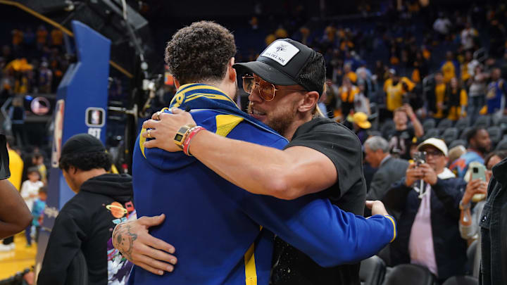 Golden State Warriors guard Klay Thompson (11) meets San Francisco 49ers tight end George Kittle (right)
