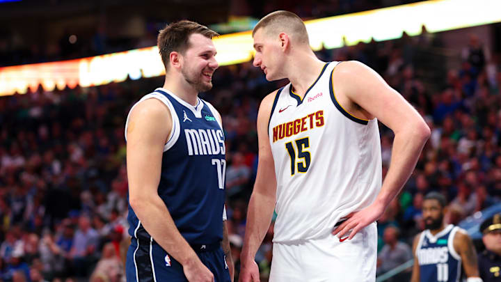 Dallas Mavericks guard Luka Doncic (77) speaks with Denver Nuggets center Nikola Jokic (15) during the second half at American Airlines Center. Mandatory Credit: Kevin Jairaj-Imagn Images
