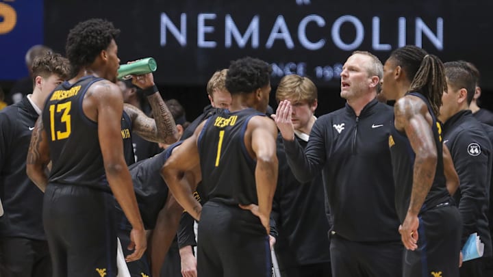 Feb 8, 2025; Morgantown, West Virginia, USA; West Virginia Mountaineers head coach Darian DeVries talks to his team late during the second half against the Utah Utes at WVU Coliseum. Mandatory Credit: Ben Queen-Imagn Images