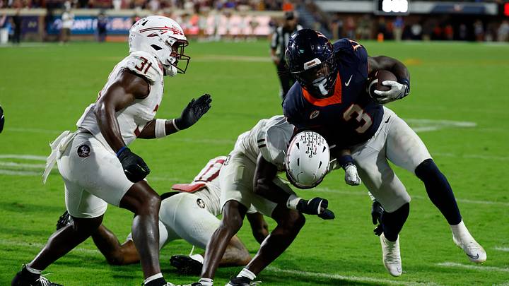 Sep 26, 2025; Charlottesville, Virginia, USA; Virginia Cavaliers running back J'Mari Taylor (3) carries the ball as Florida State Seminoles defensive back Ja'Bril Rawls (11) tacklels in the second overtime at Scott Stadium. Mandatory Credit: Geoff Burke-Imagn Images Sep 26, 2025; Charlottesville, Virginia, USA; Virginia Cavaliers running back J'Mari Taylor (3) carries the ball as Florida State Seminoles defensive back Ja'Bril Rawls (11) tacklels in the second overtime at Scott Stadium. Mandatory Credit: Geoff Burke-Imagn Images