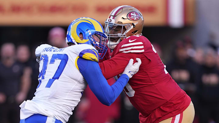 Jan 7, 2024; Santa Clara, California, USA; San Francisco 49ers guard Jaylon Moore (right) blocks Los Angeles Rams linebacker Michael Hoecht (97) during the third quarter at Levi's Stadium. Mandatory Credit: Darren Yamashita-Imagn Images