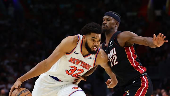 Oct 30, 2024; Miami, Florida, USA; New York Knicks center Karl-Anthony Towns (32) drives to the basketball against Miami Heat forward Jimmy Butler (22) during the fourth quarter at Kaseya Center. Mandatory Credit: Sam Navarro-Imagn Images
