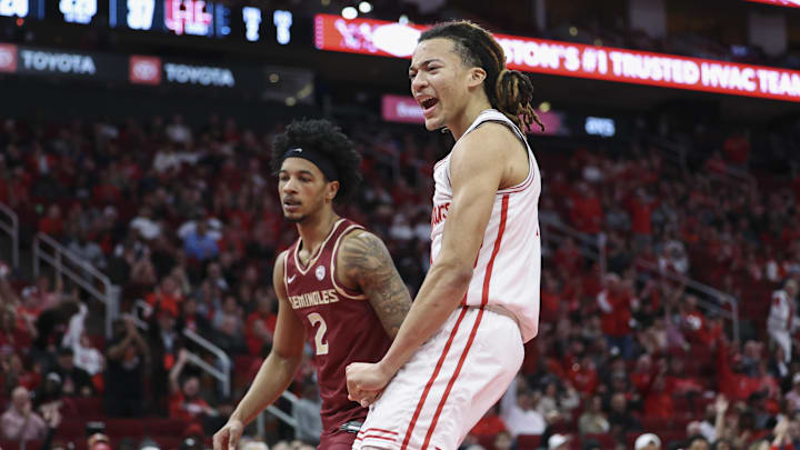 Florida State Seminoles guard Cam Miles looks on as Houston Cougars guard Kingston Flemings celebrates after scoring a basket during the first half at Toyota Center. Florida State Seminoles guard Cam Miles looks on as Houston Cougars guard Kingston Flemings celebrates after scoring a basket during the first half at Toyota Center.