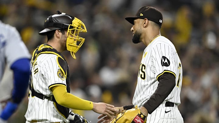Oct 8, 2024; San Diego, California, USA; San Diego Padres catcher Kyle Higashioka (20) celebrates with pitcher Robert Suarez (75) after defeating the Los Angeles Dodgers during game three of the NLDS for the 2024 MLB Playoffs at Petco Park.  Mandatory Credit: Denis Poroy-Imagn Images