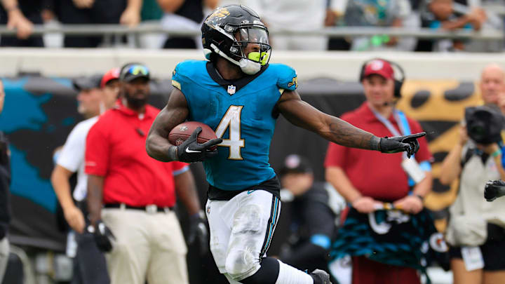 Jacksonville Jaguars running back Tank Bigsby (4) outpaces Indianapolis Colts cornerback Samuel Womack III (33) for a touchdown score during the fourth quarter of an NFL football matchup Sunday, Oct. 6, 2024 at EverBank Stadium in Jacksonville, Fla. The Jaguars edged the Colts on a field goal 37-34. [Corey Perrine/Florida Times-Union]