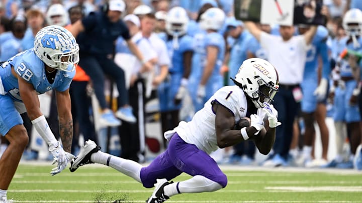 Sep 21, 2024; Chapel Hill, North Carolina, USA; James Madison Dukes wide receiver Cam Ross (1) catches a long pass as North Carolina Tar Heels defensive back Alijah Huzzie (28) defends in the second quarter at Kenan Memorial Stadium. Mandatory Credit: Bob Donnan-Imagn Images