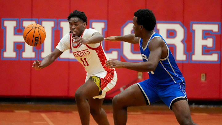 Hillcrest High's PJ Jones (11) and Vestavia Hills forward Josh Milner (14) try to grab a loose ball at Hillcrest High School Tuesday, Dec. 10, 2024.