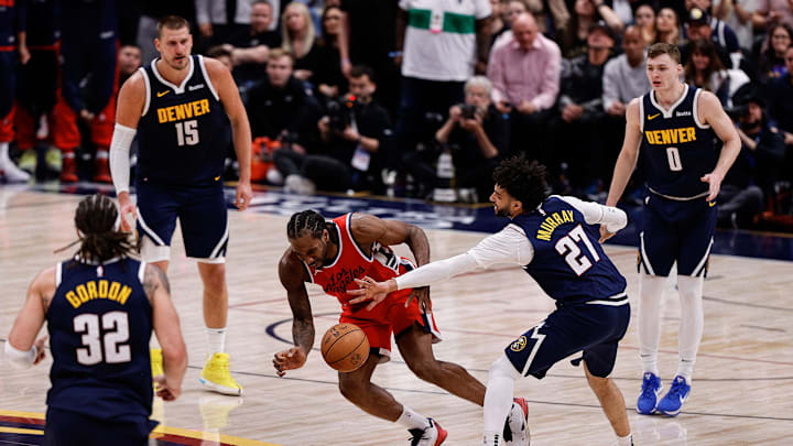 Apr 21, 2025; Denver, Colorado, USA; Los Angeles Clippers forward Kawhi Leonard (2) and Denver Nuggets guard Jamal Murray (27) battle for a loose ball in the fourth quarter during game two of first round for the 2025 NBA Playoffs at Ball Arena. Mandatory Credit: Isaiah J. Downing-Imagn Images