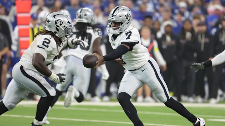 Oct 5, 2025; Indianapolis, Indiana, USA; Las Vegas Raiders quarterback Geno Smith (7) hands the ball off to running back Ashton Jeanty (2) against the Indianapolis Colts during the second quarter at Lucas Oil Stadium. Mandatory Credit: Trevor Ruszkowski-Imagn Images