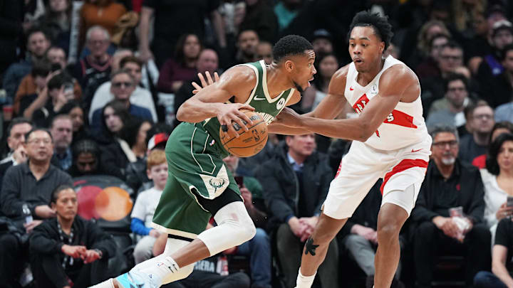 Jan 6, 2025; Toronto, Ontario, CAN; Milwaukee Bucks forward Giannis Antetokounmpo (34) controls the ball as Toronto Raptors forward Scottie Barnes (4) defends during the third quarter at Scotiabank Arena. Mandatory Credit: Nick Turchiaro-Imagn Images