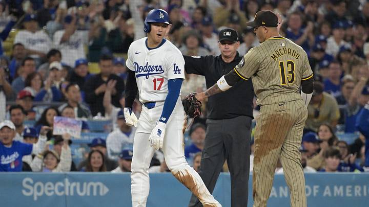 Sep 26, 2024; Los Angeles, California, USA;  Los Angeles Dodgers designated hitter Shohei Ohtani (17) and San Diego Padres third baseman Manny Machado (13) talk on the base during the seventh inning at Dodger Stadium. Mandatory Credit: Jayne Kamin-Oncea-Imagn Images