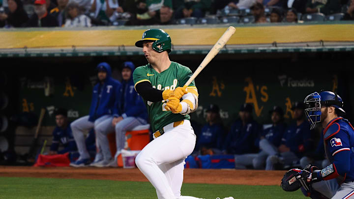 Sep 25, 2024; Oakland, California, USA; Oakland Athletics designated hitter Brent Rooker (25) hits a single against the Texas Rangers during the first inning at Oakland-Alameda County Coliseum. Mandatory Credit: Kelley L Cox-Imagn Images
