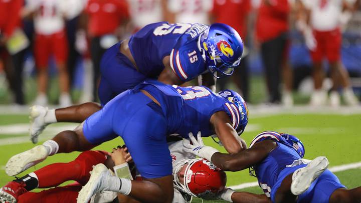 Kansas Jayhawks defensive end Leroy Harris III (33) makes a sack against Fresno State Bulldogs quarterback E.J. Warner (13) during the game between Fresno State and Kansas at David Booth Kansas Memorial Stadium on Aug. 23, 2025.