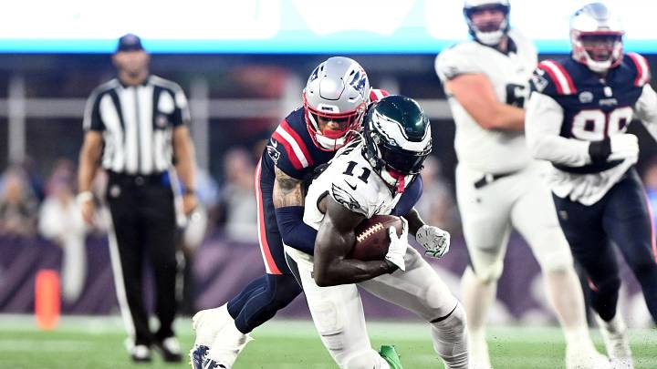 Sep 10, 2023; Foxborough, Massachusetts, USA; Philadelphia Eagles wide receiver A.J. Brown (11) is tackled by New England Patriots cornerback Christian Gonzalez (6) during the second half at Gillette Stadium. Mandatory 