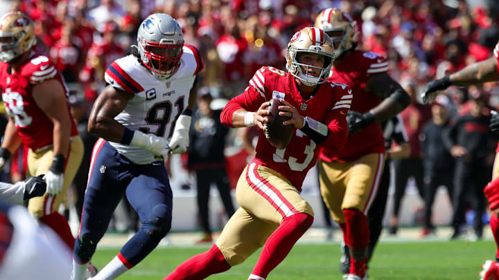 Sep 29, 2024; Santa Clara, California, USA; San Francisco 49ers quarterback Brock Purdy (13) scrambles with the ball against the New England Patriots during the second quarter at Levi's Stadium. Mandatory Credit: Sergio Estrada-Imagn Images