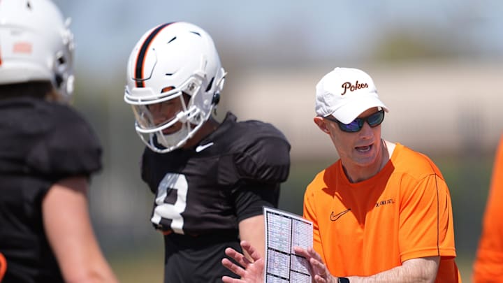 Oklahoma State quarterbacks coach Kevin Johns runs drills with the quarterbacks during a Spring football practice at Oklahoma State University in Stillwater, Okla., Tuesday, April, 8, 2025.