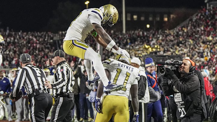 Nov 29, 2024; Athens, Georgia, USA; Georgia Tech Yellow Jackets running back Jamal Haynes (11) reacts with wide receiver Malik Rutherford (8) after scoring a touchdown quarterback Haynes King (10) reacts with against the Georgia Bulldogs during the first half at Sanford Stadium. Mandatory Credit: Dale Zanine-Imagn Images