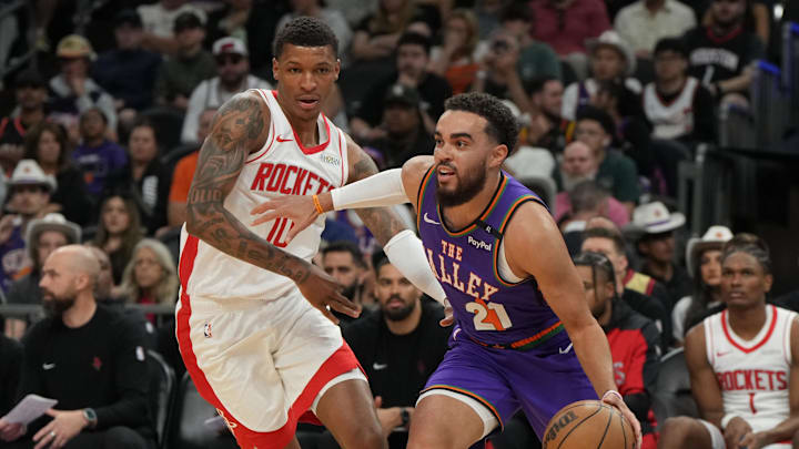 Mar 30, 2025; Phoenix, Arizona, USA; Phoenix Suns guard Tyus Jones (21) drives on Houston Rockets forward Jabari Smith Jr. (10) in the first half at Footprint Center. Mandatory Credit: Rick Scuteri-Imagn Imagesd