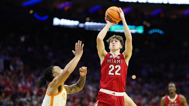 Miami (Ohio) RedHawks forward Brant Byers (22) takes a shot as Tennessee Volunteers guard Amari Evans (1) defends during the first half during a first round game of the men's 2026 NCAA Tournament at Xfinity Mobile Arena.