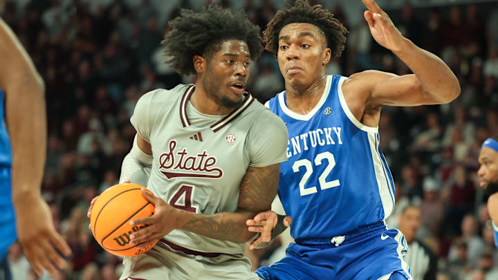 Jan 11, 2025; Starkville, Mississippi, USA; Mississippi State Bulldogs forward Cameron Matthews (4) handles the ball against Kentucky Wildcats center Amari Williams (22) during the second half at Humphrey Coliseum. Mandatory Credit: Wesley Hale-Imagn Images