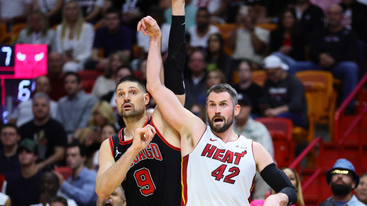 Apr 19, 2024; Miami, Florida, USA; Miami Heat forward Kevin Love (42) watches his shot against Chicago Bulls center Nikola Vucevic (9) in the fourth quarter during a play-in game of the 2024 NBA playoffs at Kaseya Center. Mandatory Credit: Sam Navarro-USA TODAY Sports