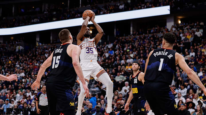 Mar 27, 2024; Denver, Colorado, USA; Phoenix Suns forward Kevin Durant (35) attempts a shot against Denver Nuggets center Nikola Jokic (15) and forward Michael Porter Jr. (1) in the fourth quarter at Ball Arena. Mandatory Credit: Isaiah J. Downing-Imagn Images