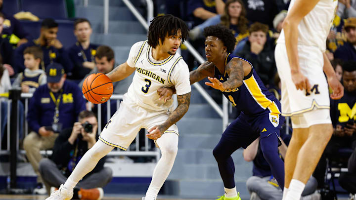 Dec 21, 2025; Ann Arbor, Michigan, USA; Michigan Wolverines guard Elliot Cadeau (3) handles the ball against La Salle Explorers guard Truth Harris (4) during the second half at Crisler Center. Mandatory Credit: Brian Bradshaw Sevald-Imagn Images