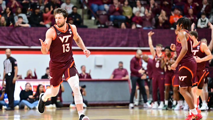 Feb 15, 2025; Blacksburg, Virginia, USA; Virginia Tech Hokies forward Ben Burnham (13) celebrates a three point basket during the second half against the Virginia Cavaliers at Cassell Coliseum. Mandatory Credit: Brian Bishop-Imagn Images